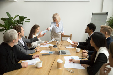Senior businesswoman company boss ceo handing financial statistical report to executive manager...