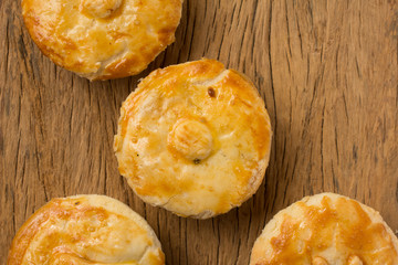 Stuffed chicken pie known as Empada in Portugal and Brazil. Group of snacks on rustic wood, flat lay design.