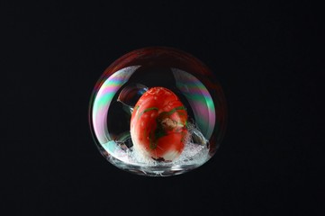 Red egg in colorful and big bubble