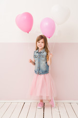 Happy kid celebrating party with balloons top view. Little girl in birthday party.
