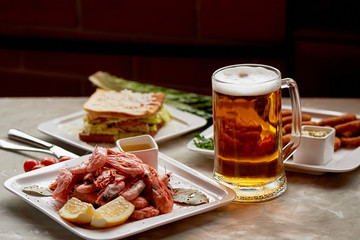 Beer snack in the pub or bar. Beer, shrimps and nuts.