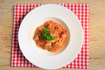 Top view SpaghettiMarinara  on wooden background.