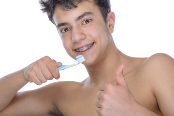 Teen boy wearing braces on white background