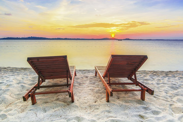 Fototapeta na wymiar Beach chair at sunset