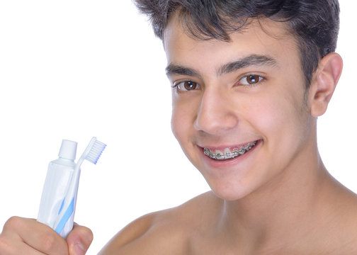 Teen boy wearing braces on white background