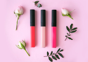 Lip gloss with flowers on a pink background