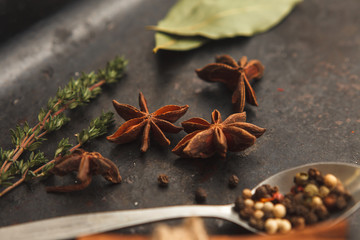 A lot of herbs and spices on black old table