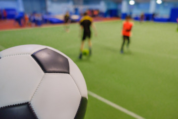 Soccer Ball on Stadium and football players defocused in field