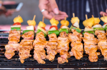 Man hand is grilling barbecue on the stove.