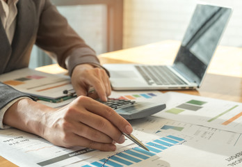 Business concepts,Man hand holding pen pointing at graph on desk,Business concepts.