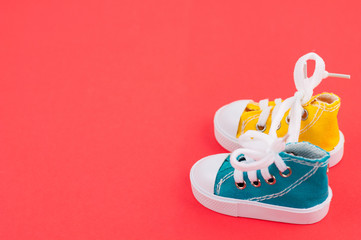 Pair of new yellow and green color gym shoes on red paper