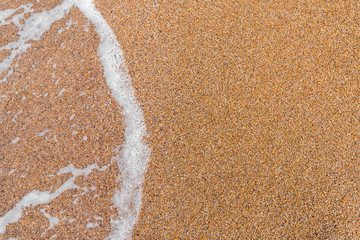 Fototapeta na wymiar Golden sand and sea wave background
