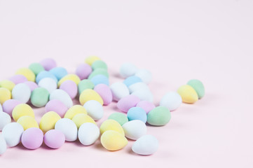 pastel colored easter eggs on a pink background