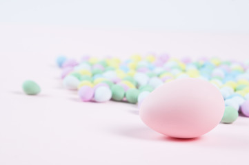 pastel colored easter eggs on a pink background