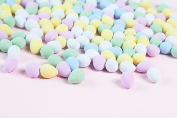 pastel colored easter eggs on a pink background