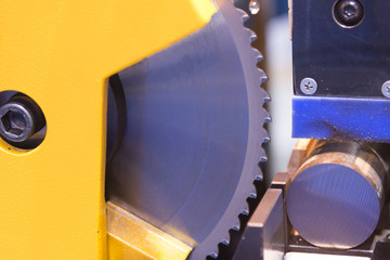 The circular blade saw machine cutting the metal rod.Raw material for manufacturing process.