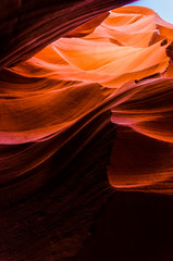 Orange peach wave shapes photographed at slots canyons in Arizona with blue sky