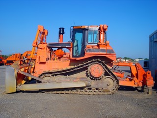 Orange bulldozer parked on construction site