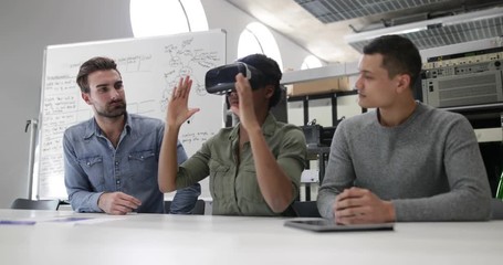 Team working on virtual reality headset - Powered by Adobe