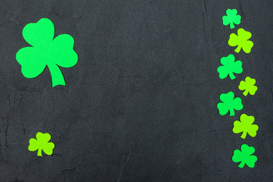 St. Patrick's Day theme colorful horizontal banner. Green shamrock leaves on black background. Felt craft elements. Copy space. For greeting card, banner
