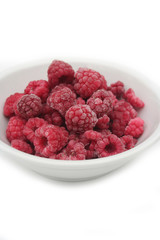 Frozen raspberries isolated on white background