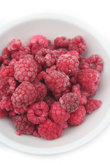 Frozen raspberries isolated on white background