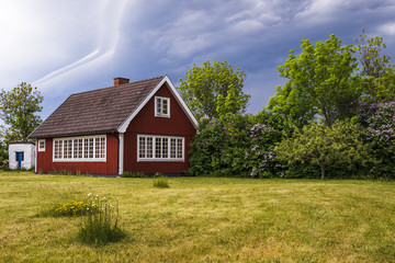 Fototapeta na wymiar A red and white summerhaus in Sweden