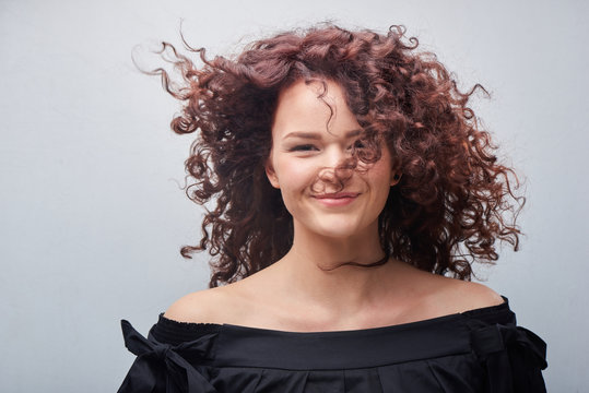 Portrait of young woman with trend curly hair, professional hair coloring