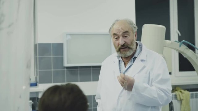 Doctors takling with co-worker on break in the rest room. 4K