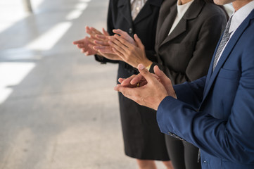 business man and business woman clap their hands to congratulate the signing of an agreement or contract between their companies. success, dealing, greeting and partner concept.