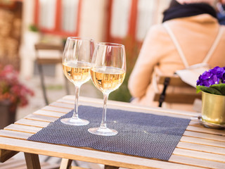 Two glasses of white wine served in a small cafe in the Old Town of Porto, Portugal.