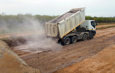 View of dump truck dumping gravel