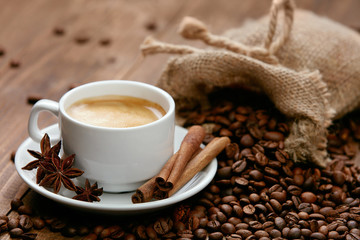 Cup Of Coffee And Coffee Beans On Table.