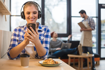 Joyful beautiful woman listening to her favourite song