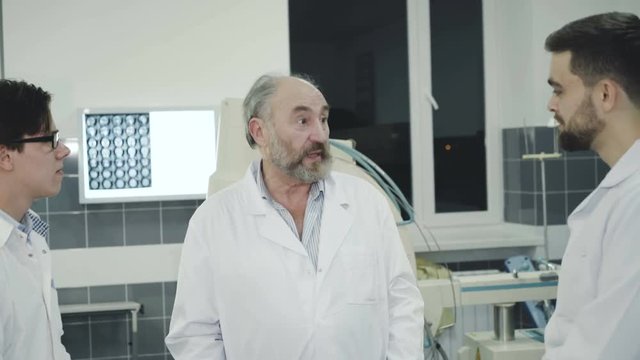 Doctors takling with co-worker on break in the rest room in hospital
