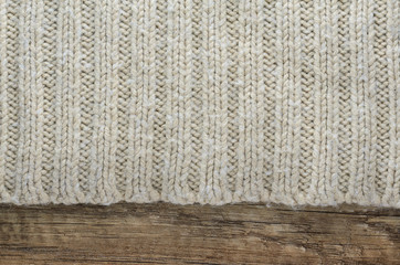 Knit texture of wool knitted fabric on wood background. Blank Backdrop