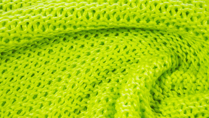 Beautiful knitted background of green yarn.