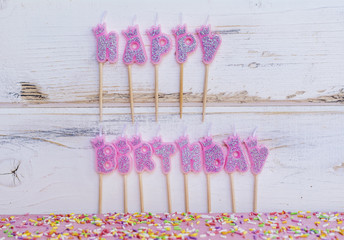 Pink Birthday Candles on a White Wooden Background.Happy Birthday Concept