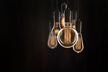 Vintage bulbs on black background - idea, innovation, teamwork and leadership concept. Space for...