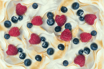 The texture of the meringue cake with blueberries and raspberries