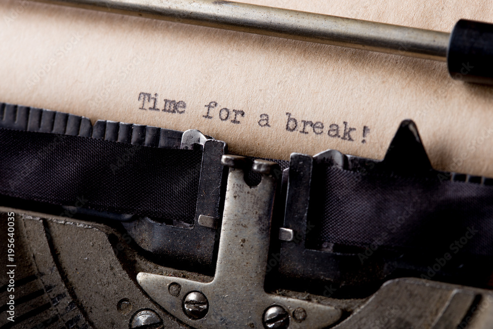 Poster time for a break - text message on the typewriter close-up