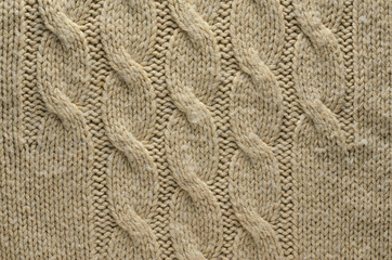 Knit Texture of Beige Wool Knitted Fabric with Cable Knits Pattern. Blank Background