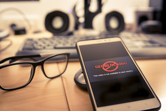 Smartphone in office and being unable to navigate online.Geo-blocking concept.