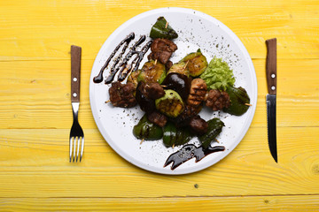 Appetizer and cooking concept. Roasted pork and grilled vegetables