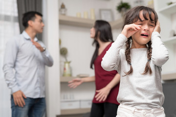 Domestic violence and Family conflict concept. Sadness little girl against blured of mother fighting father with quarrel at home. - obrazy, fototapety, plakaty