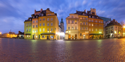 Fototapeta na wymiar Panoramic view of Castle Square with colorful houses, Piwna street and Bell tower of St. Martin's Church in Old town during morning blue hour, Warsaw, Poland.