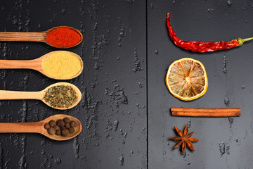 Wooden spoons with paprika, turmeric, herbs and pepper