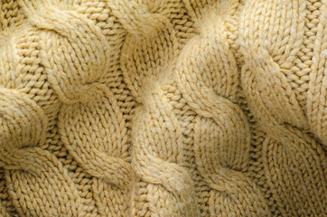 Beige Sweater Texture Close-Up. Elements of Knitted Sweater as Background