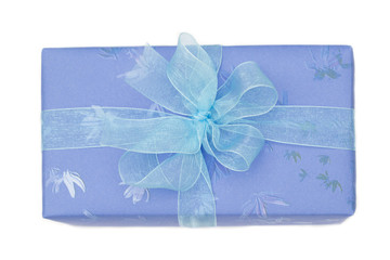 Gift box with blue wrapping paper and bow isolated on white
