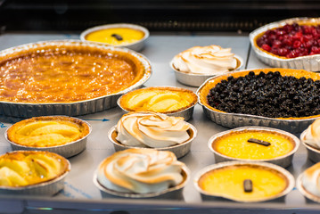 the counter of the cafe with different desserts